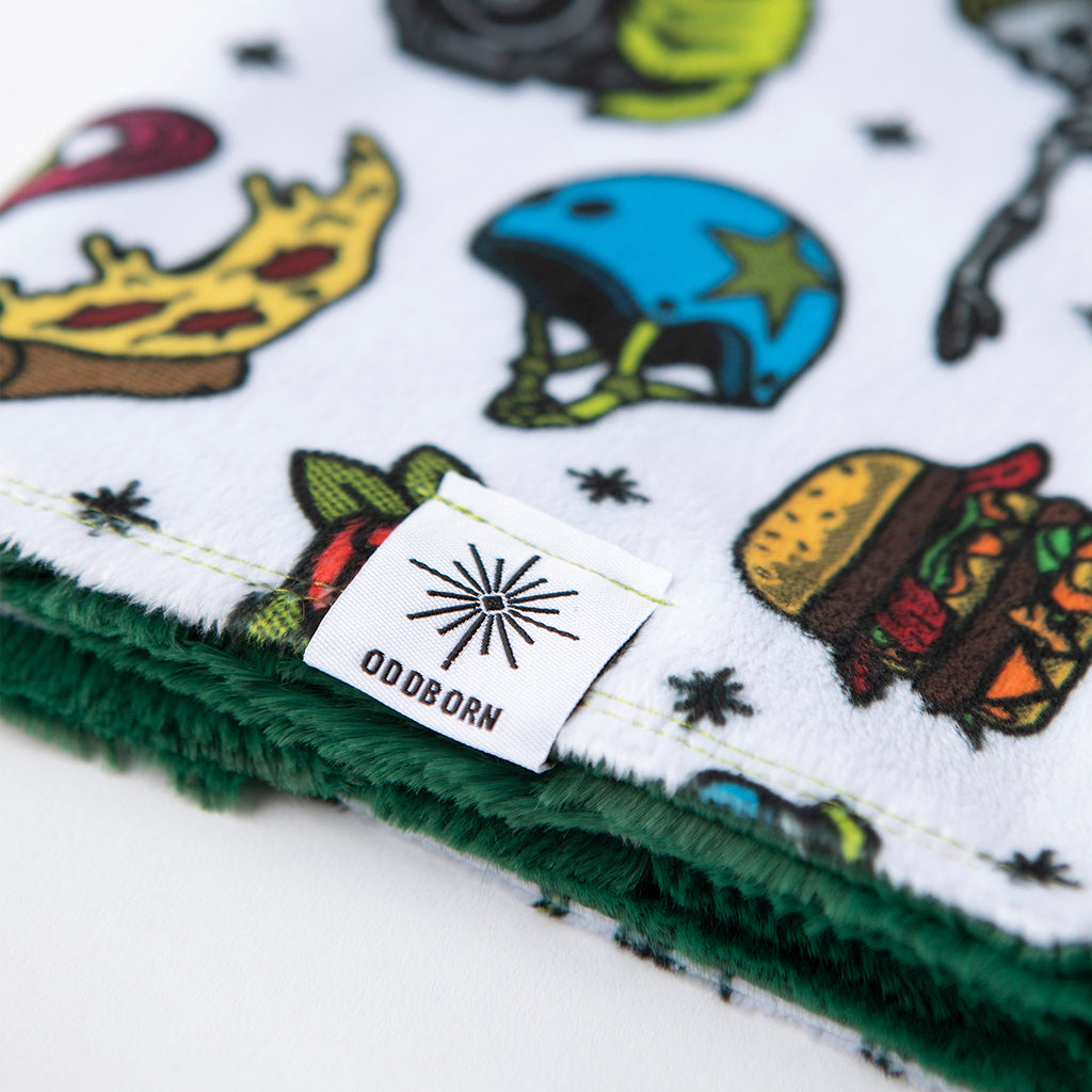 This minky baby lovie or baby security blanket features skeletons and zombie hands all over the blankie. this image shows the OddBorn logo tag